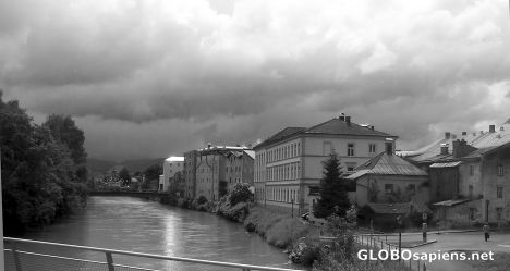 Postcard Heavy clouds & curving building along the Salzach