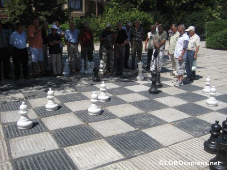 Postcard People playing giant chess in the street.