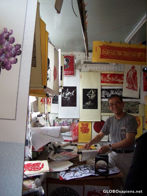 Postcard Artist showing his paper cuts in his shop, Hutong