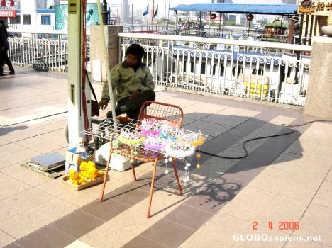 Postcard a toy vendor passing time