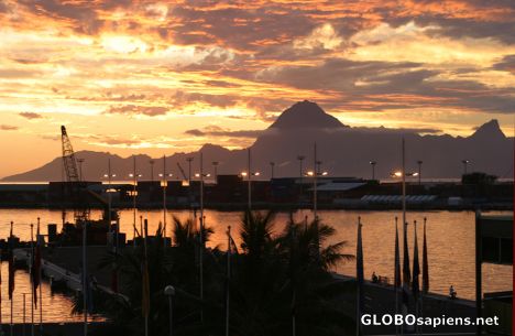 Postcard Fiery setting sun over Papeete Harbor