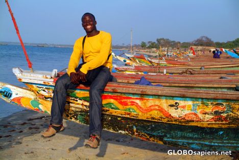 Postcard Barra - a local boy sitting on a fishing boat