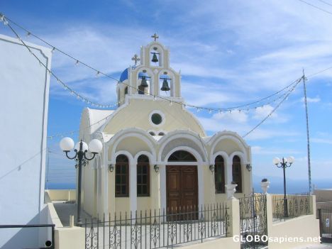 Postcard Small church in downtown Oia