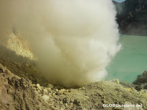 Postcard Volcano eruption on edge of dead sulphur lake..