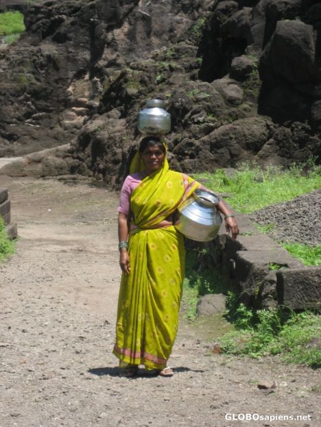 Postcard Woman collecting water from local Water Fall