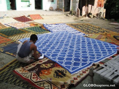Postcard Weaver lays out Handcrafted Durrie Rugs