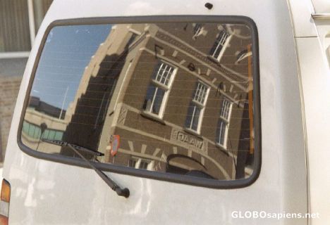 Postcard Reflection of the old weighing house in a car wind