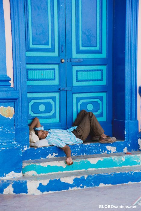 Postcard Granada - A blue door man snoozes