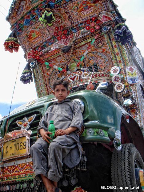 Postcard Boy posing on a beautiful decorated truck