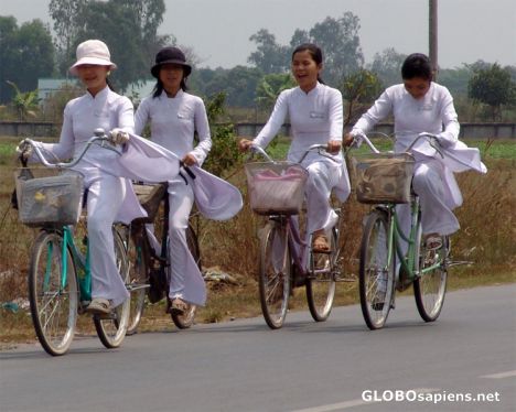 Postcard School children cycling in traditional dress