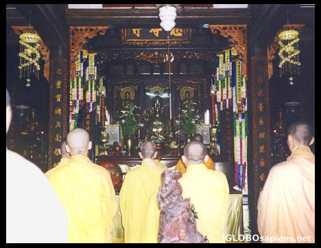 Postcard Monks praying in a temple near Hue.