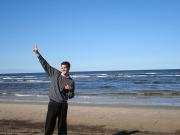 Me posing at Jurmala Beach with hand in the air.