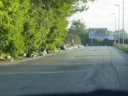 At the end of the road- the Billboard has an outline of a body with garbage surrounding it.