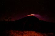 Smoking and lava flowing the Arenal Volcano - lava flowing on the right