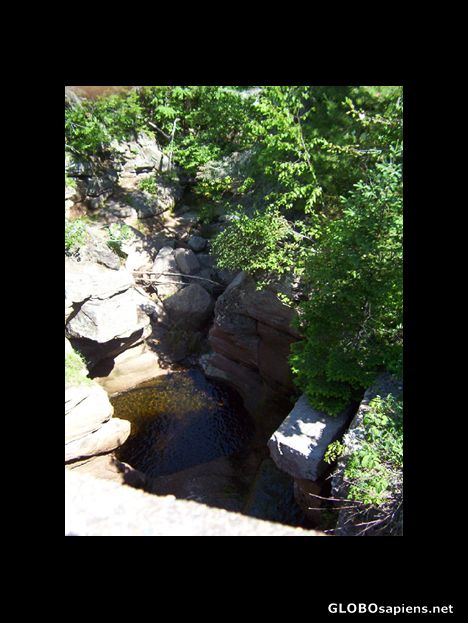 Small waterfall underneath a bridge