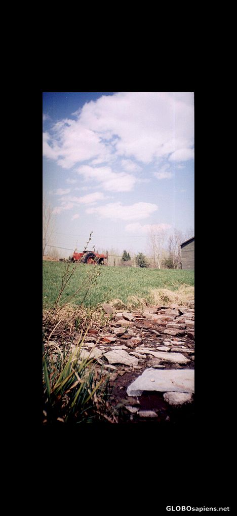 Postcard Tractor and rocks in the village of Allardville