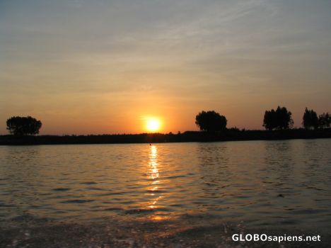 Postcard Sun setting by the Mekong Delta.