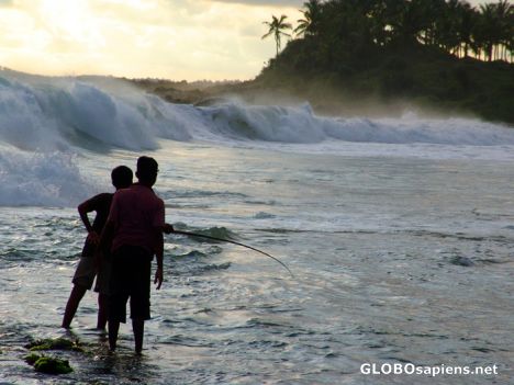 Postcard Boys fishing Dikwella's stormy seas by rod