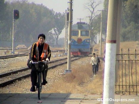 Postcard train driver on a bike
