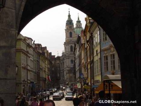 Postcard view through a bridge entryway in prague