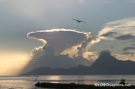 Postcard Setting sun behind a huge cumulonimbus on Moorea