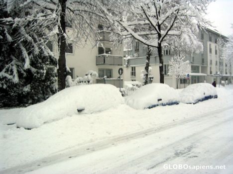 Postcard Snow covered cars all along the roads