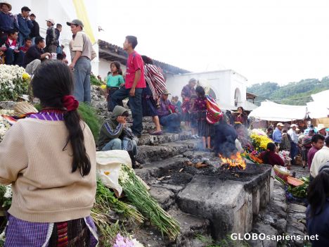 Postcard Mayan altar burns at the base of St. Tomas Church