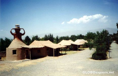 Postcard rooms beside wooden mosque