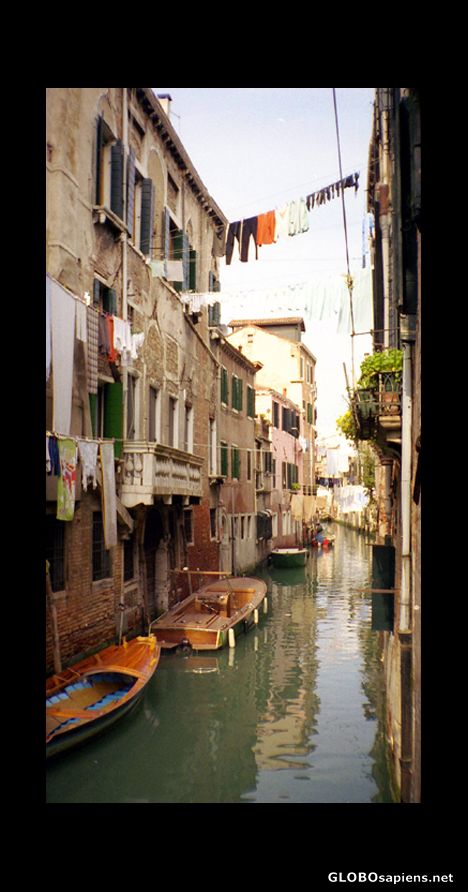 Postcard Clothes lines behind houses and family boats