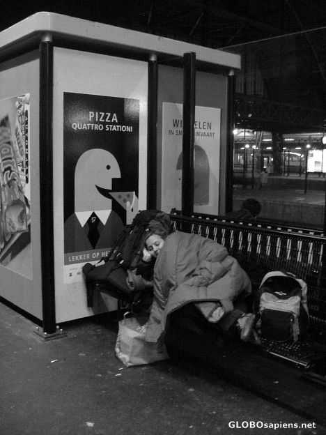Postcard homeless in Amsterdam central railway station