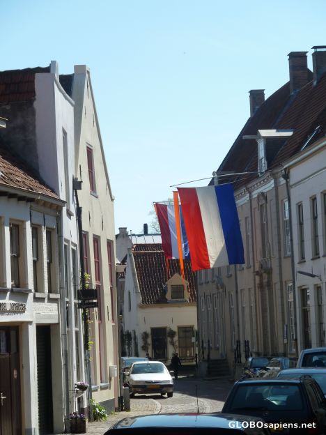 Postcard Narrow streets, cars and Queensday at Zutphen