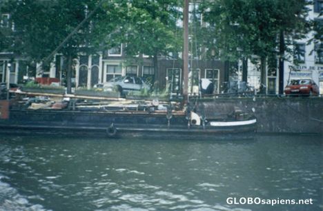 Postcard Boat full of stuff on one of the canals, Amsterdam