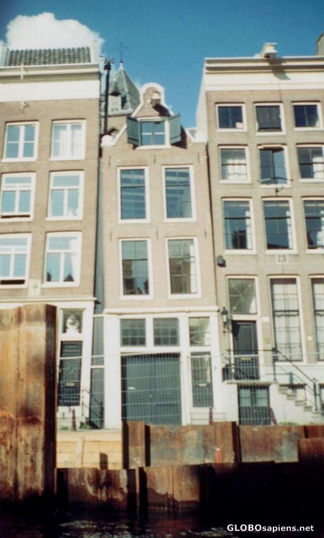 Postcard Houses by rusted metal in canal, Amsterdam