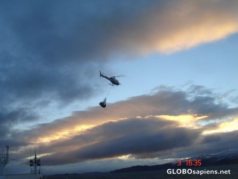 Postcard French Antarctica. Helicopter transporting cargo