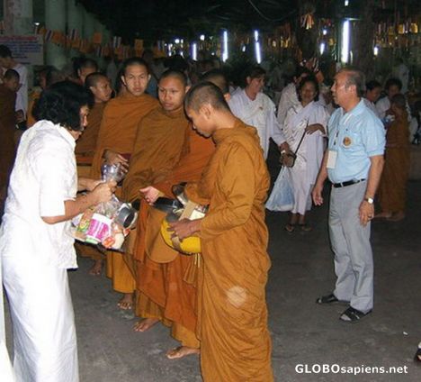 Postcard Monks receiving evening offerings