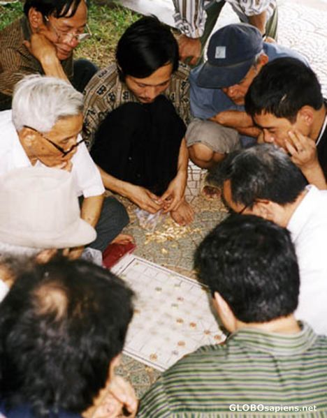 Postcard people playing chinesse chess.