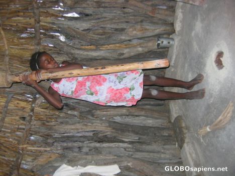 Postcard Girl grinding millet