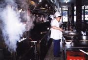 View through the kitchen door of a bigger restaurant
