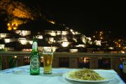 Spaghetti carbonara at the Antigoni overlooking old Berat illuminated at night.