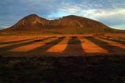 Shadow of Ahu Tongariki with view to the Rano Raraku