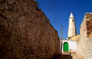 Harar's old town alley. Mosque in the background. Harar's old town alley. Mosque in the background.
