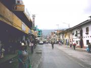 A street in Huaraz with a Semana Santa parade coming down the street.