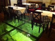 The lobby bar of the Stari Grad Hotel, glass floor revealing old foundations.