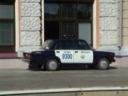 The local police cars on on od the platform next the station building.