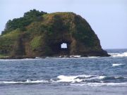 Bantay Abot in Gaoa. A rock with a hole in the midst of the sea.