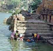 Washing clothes in the temple tank Washing clothes in the temple tank