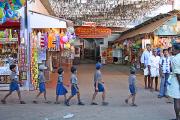 schoolchildren walk in single file past the temple entrance. schoolchildren walk in single file past the temple entrance.