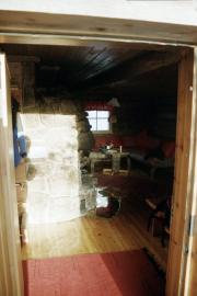 The entrance to our cottage with the fireplace on the left and the sofa to the back