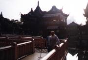 The teahouse in the lake in early morning sun with the nine dragon bridge