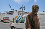 The Rhodos ferry and a passing fisherman